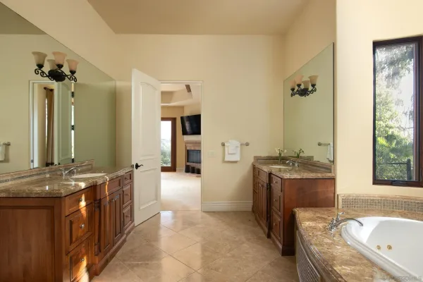 a spacious bathroom with a granite countertop tub sink and mirror