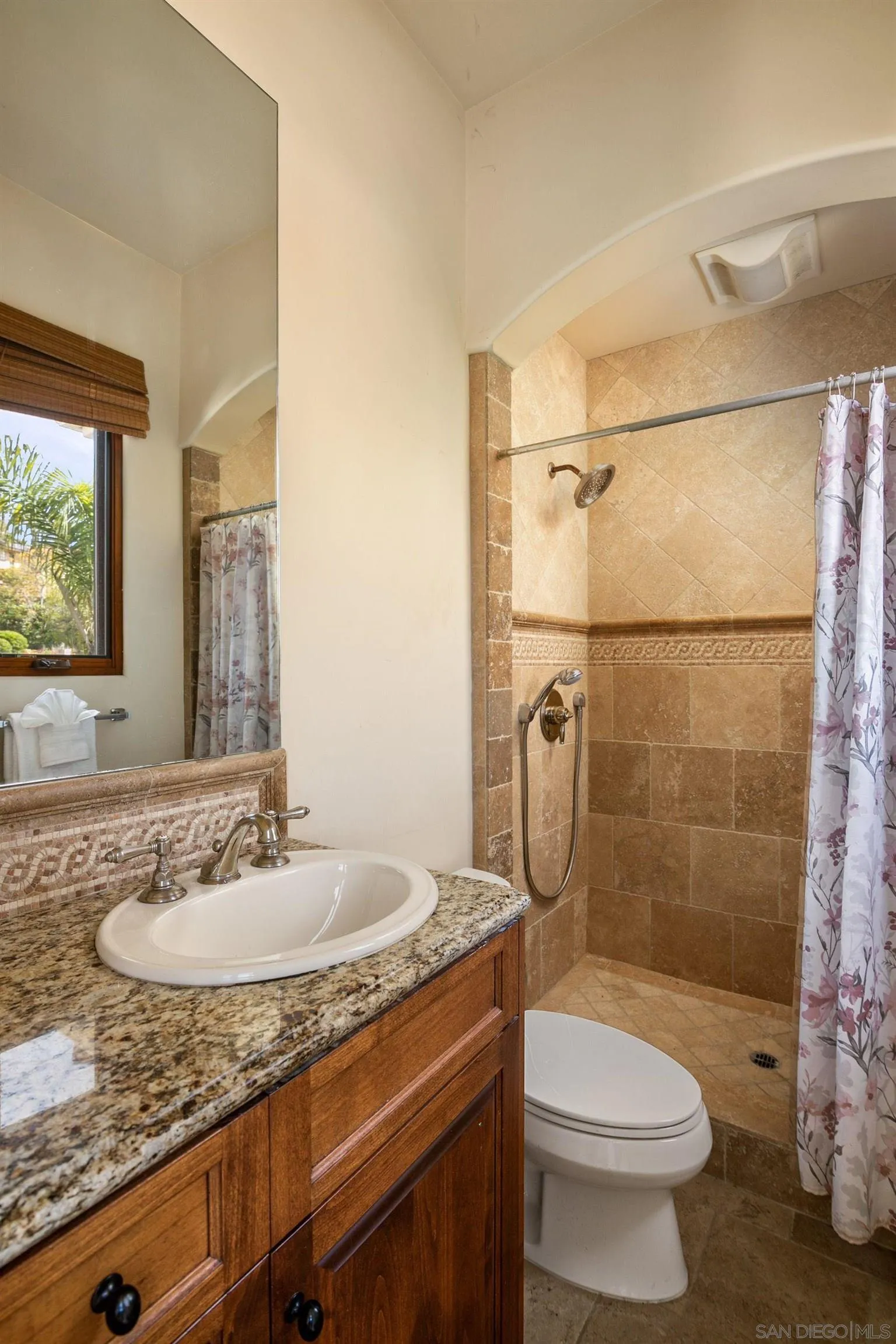 2922 Managua Place Carlsbad, CA 92009 - Photo 28 of 45 a bathroom with a granite countertop sink toilet and shower