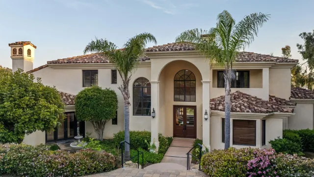 a front view of a house with plants