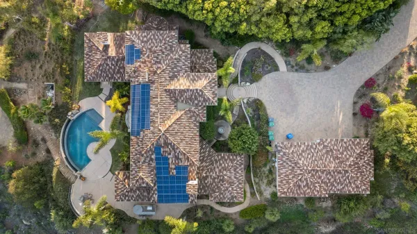 an aerial view of a house with a yard and fountain