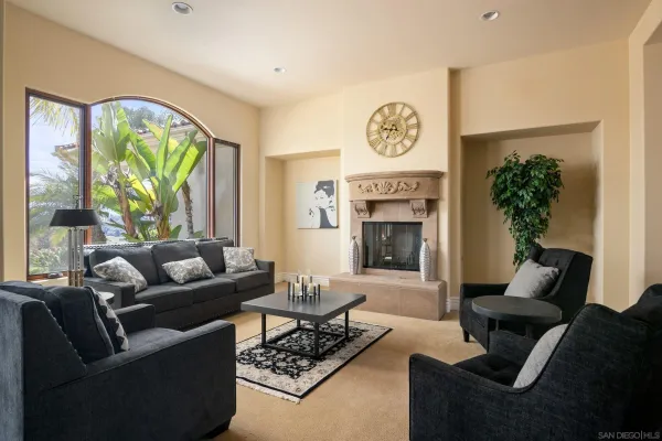 a living room with furniture a large window and a fireplace