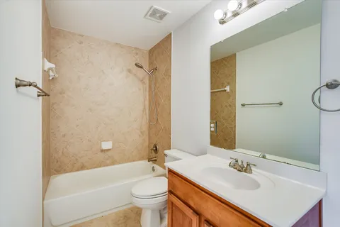 a bathroom with a sink mirror toilet and bathtub