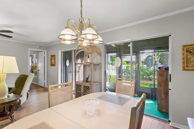 a view of a dining room with furniture wooden floor and chandelier
