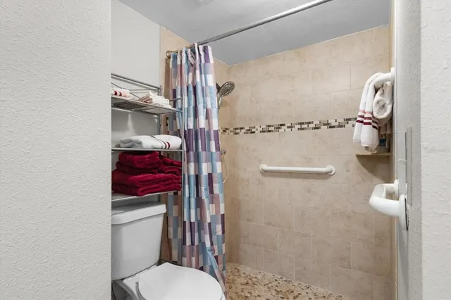 a bathroom with a toilet and a shower