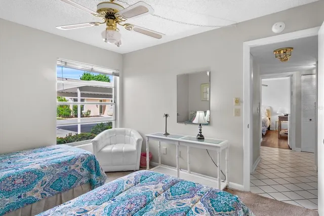 a bedroom with two beds and a chandelier