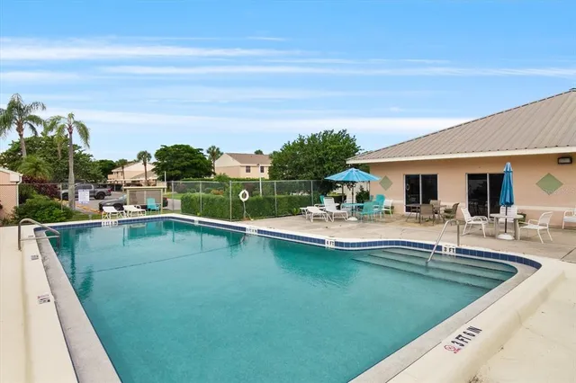 a view of a swimming pool with chairs