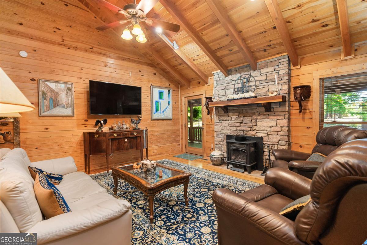 224 Harmony Road Eatonton, GA 31024 - Photo 12 of 68 a living room with furniture a flat screen tv and a fireplace
