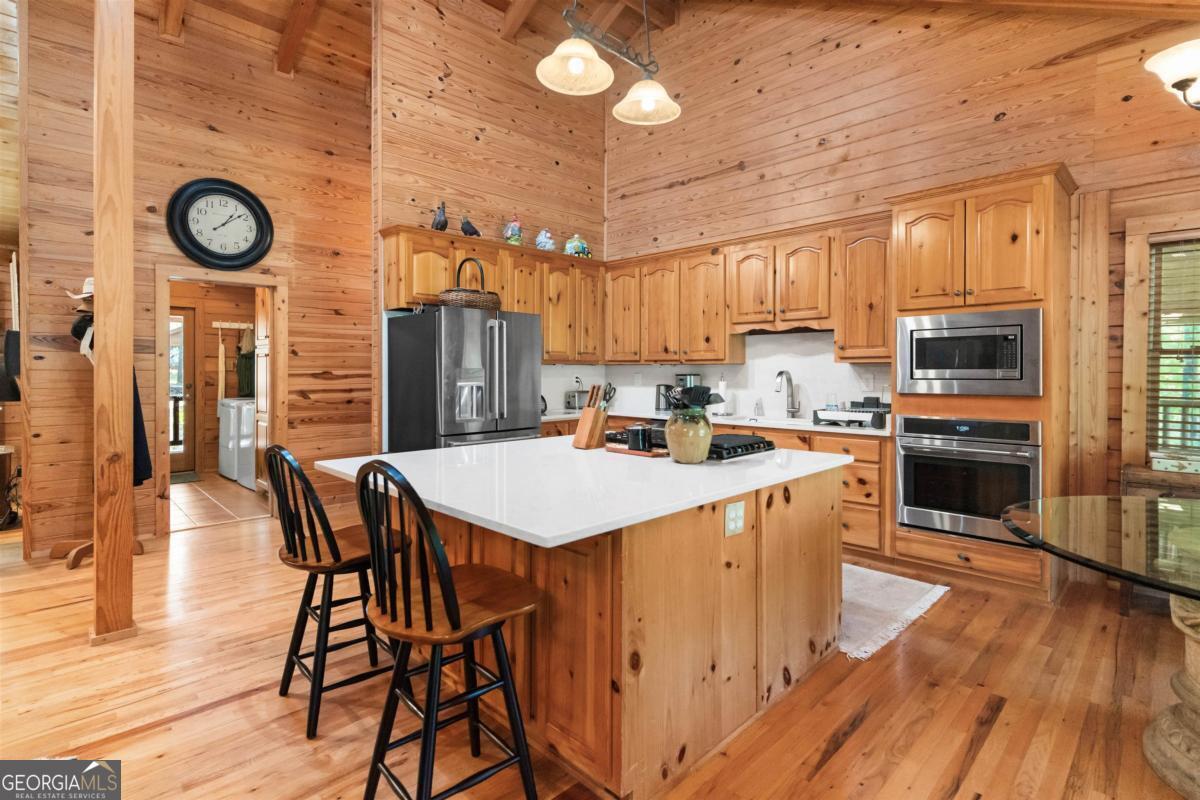 224 Harmony Road Eatonton, GA 31024 - Photo 16 of 68 a kitchen with a table chairs and a stove top oven