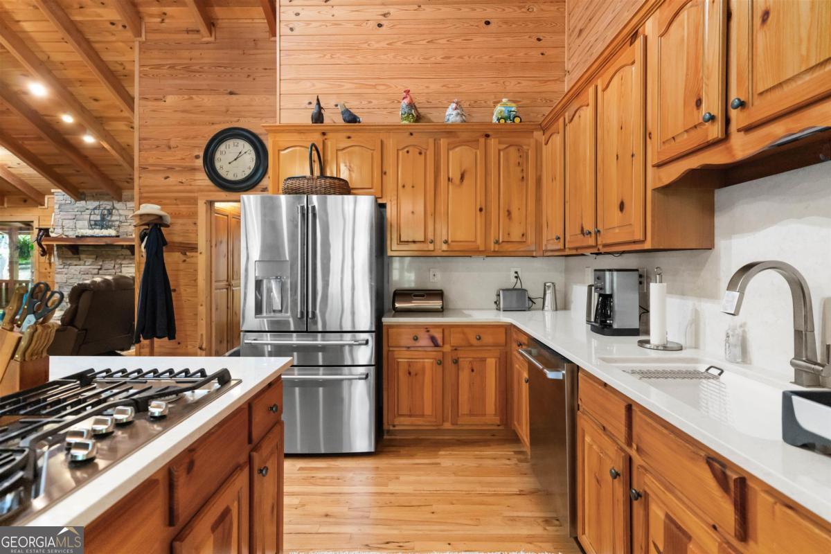 224 Harmony Road Eatonton, GA 31024 - Photo 17 of 68 a kitchen with stainless steel appliances granite countertop a stove and refrigerator