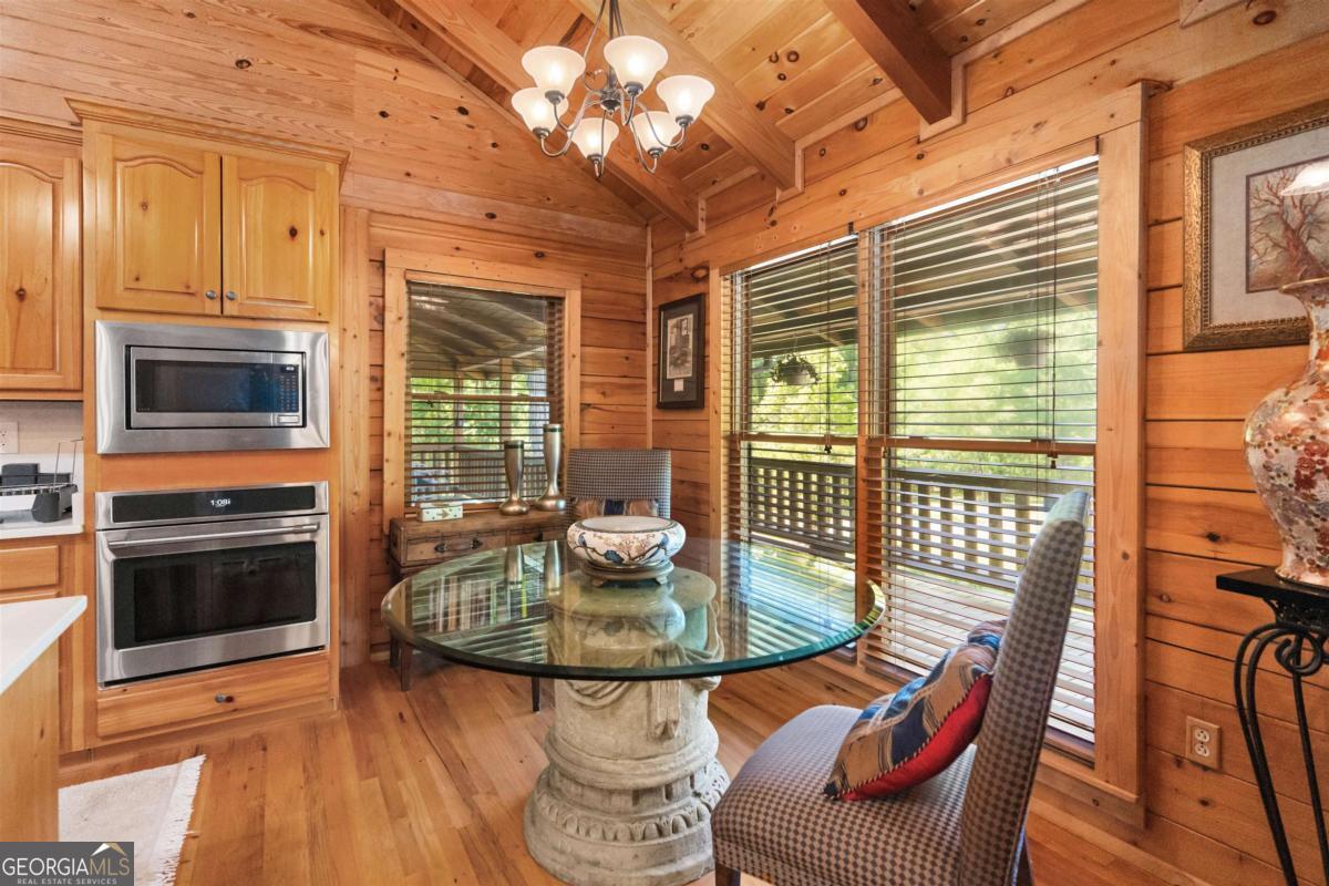 224 Harmony Road Eatonton, GA 31024 - Photo 18 of 68 a dining room with furniture and wooden floor