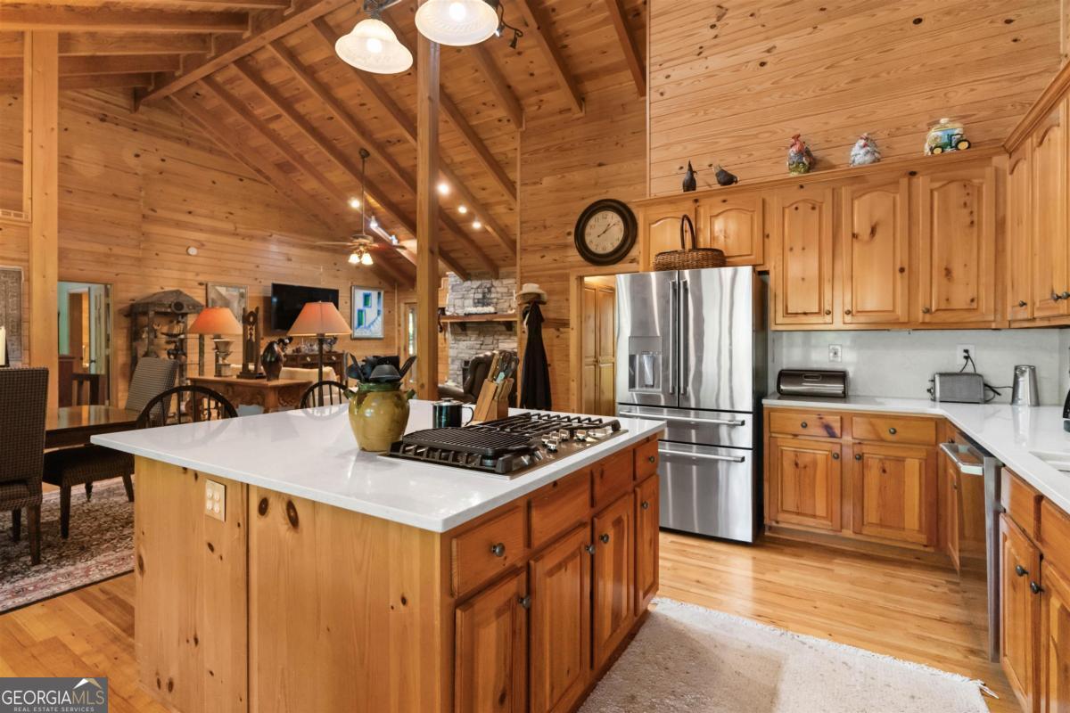 224 Harmony Road Eatonton, GA 31024 - Photo 19 of 68 a kitchen with stainless steel appliances granite countertop a sink a stove and a refrigerator