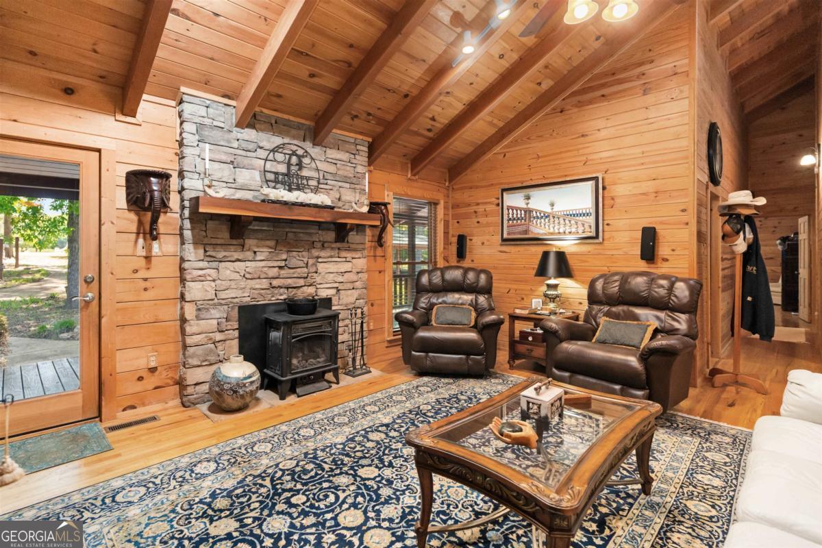 224 Harmony Road Eatonton, GA 31024 - Photo 21 of 68 a living room with furniture and a fireplace
