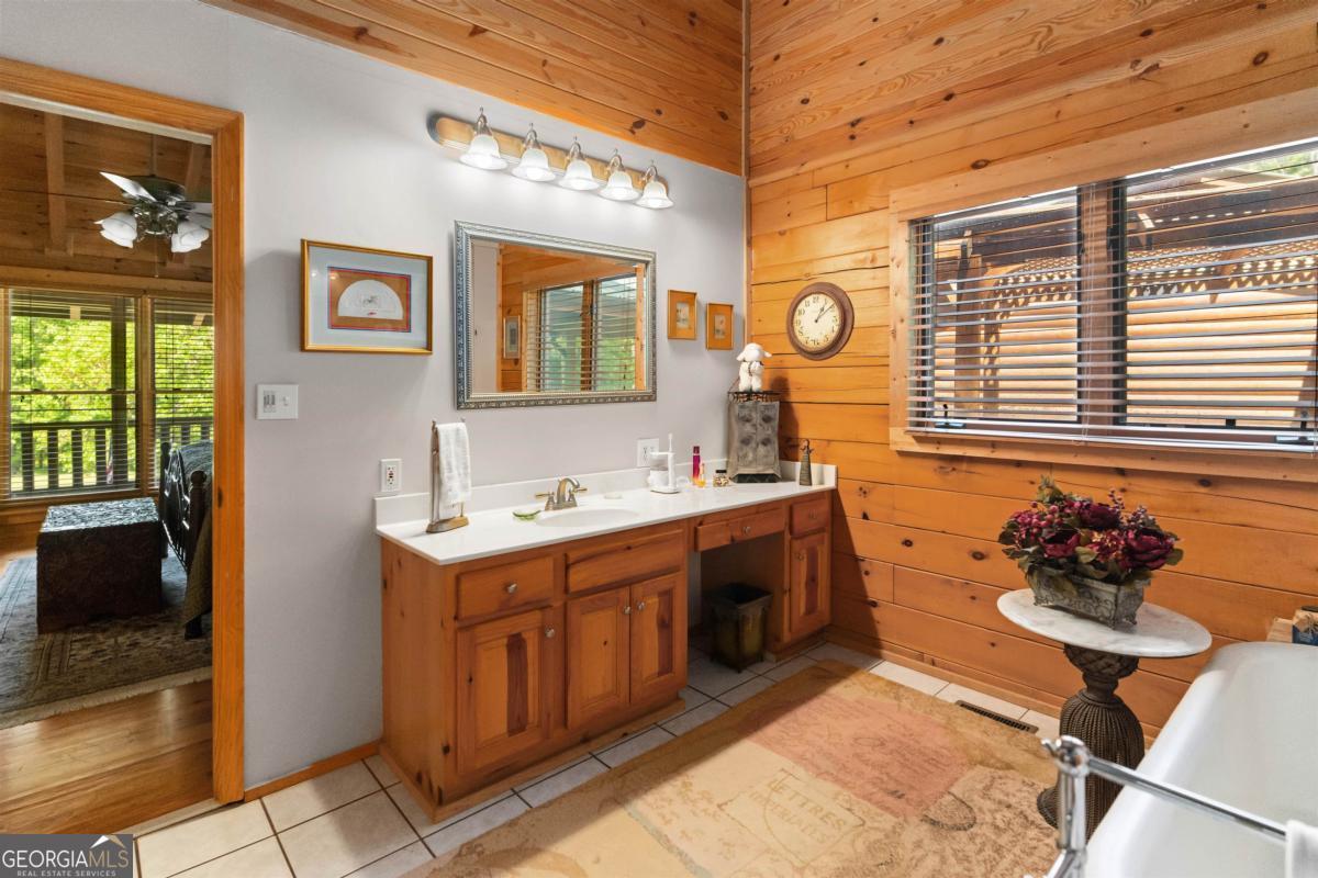 224 Harmony Road Eatonton, GA 31024 - Photo 24 of 68 a bathroom with a sink a vanity and a mirror