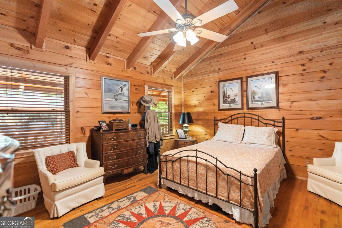 224 Harmony Road Eatonton, GA 31024 - Photo 27 of 68 a bedroom with furniture and a flat screen tv