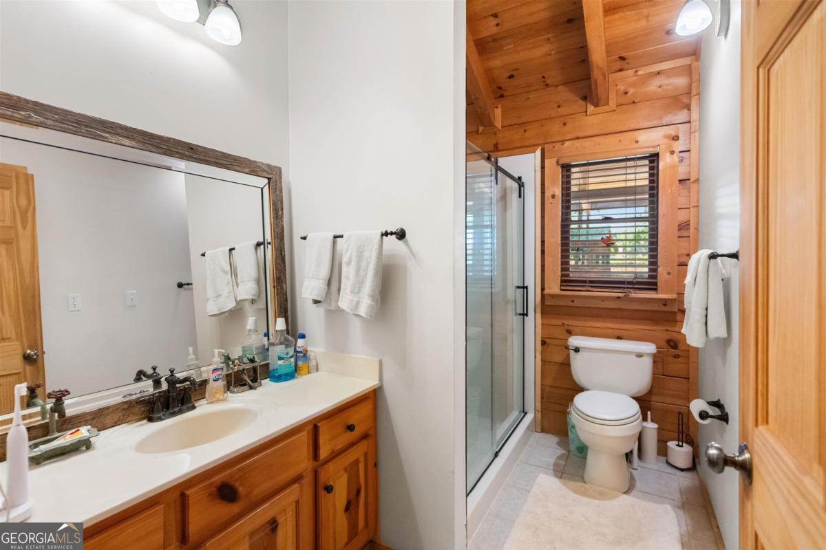 224 Harmony Road Eatonton, GA 31024 - Photo 28 of 68 a bathroom with a sink a toilet and shower
