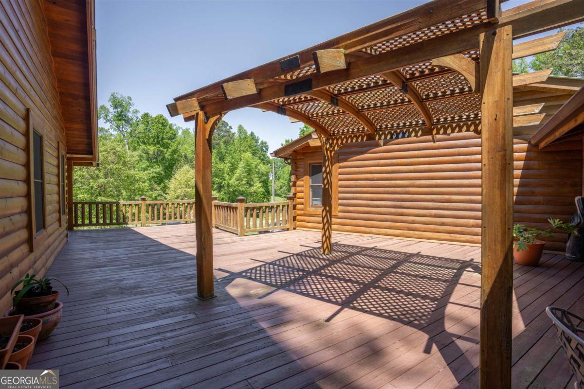 224 Harmony Road Eatonton, GA 31024 - Photo 35 of 68 a view of backyard with wooden floor and iron fence