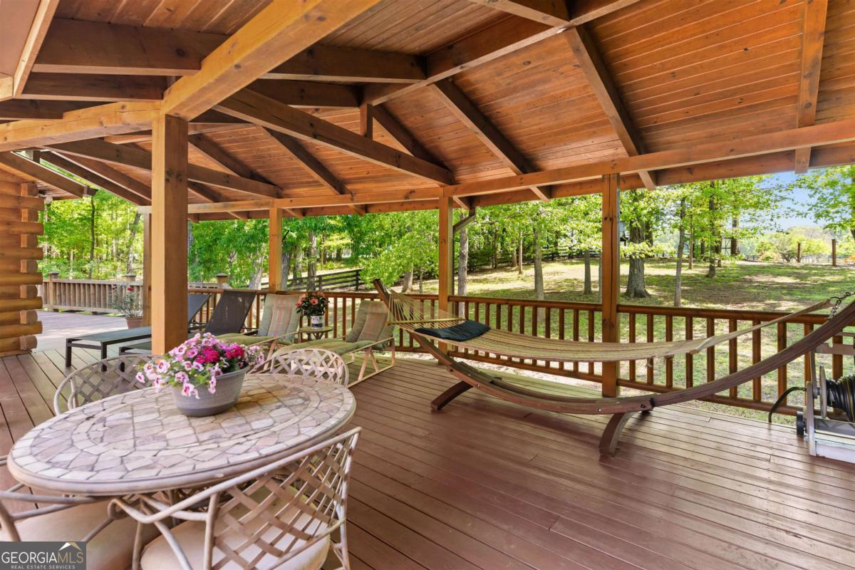 224 Harmony Road Eatonton, GA 31024 - Photo 36 of 68 a view of a patio with a table chairs and a patio