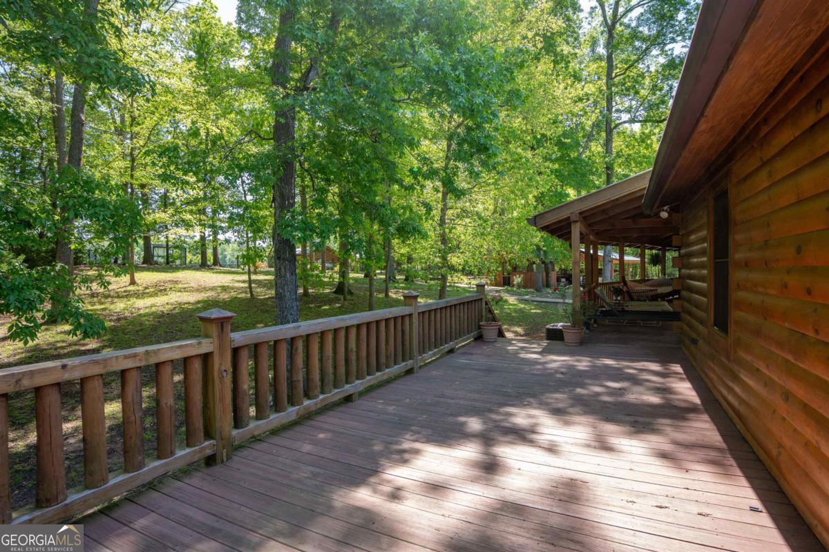 224 Harmony Road Eatonton, GA 31024 - Photo 41 of 68 a view of backyard with deck and outdoor seating