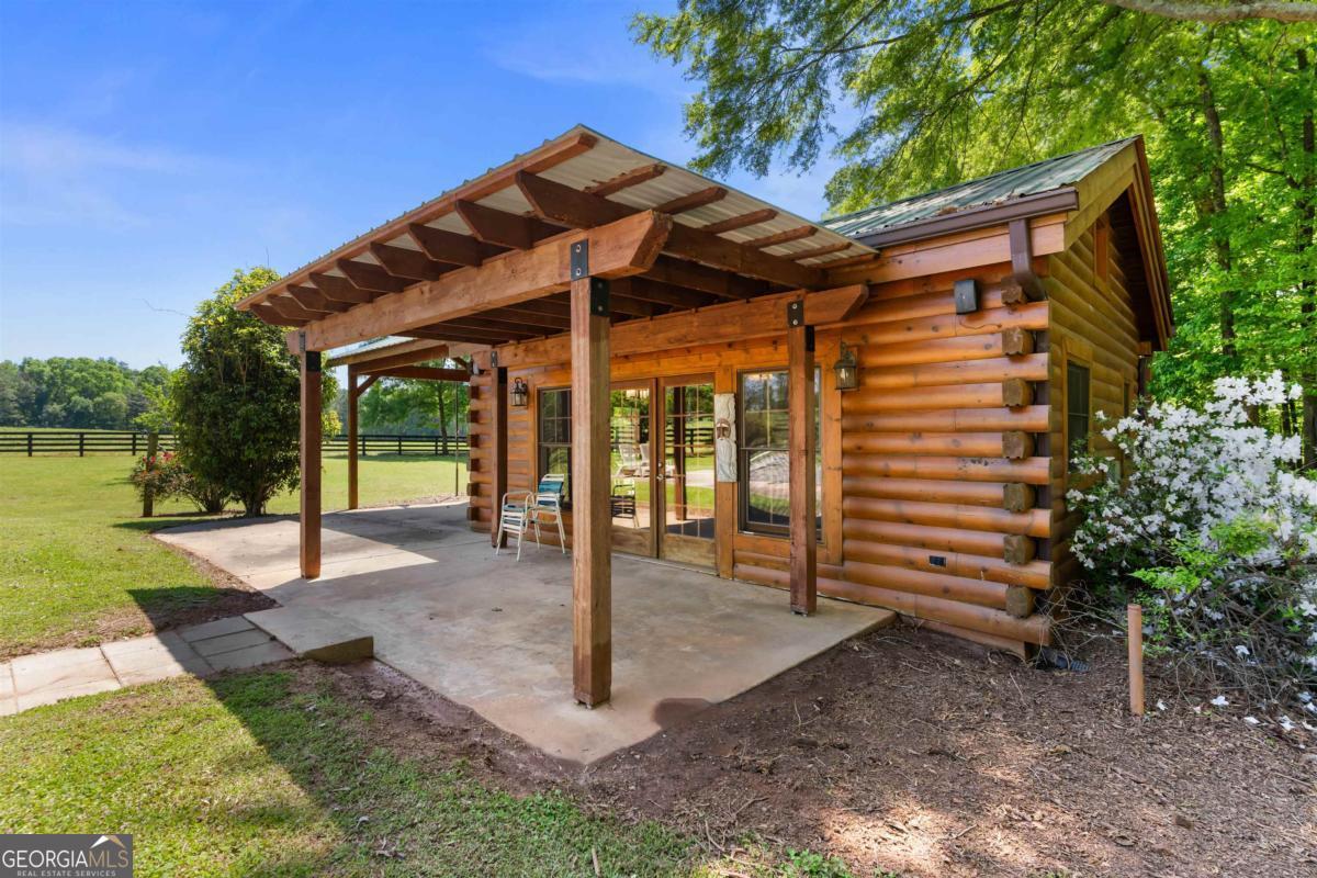 224 Harmony Road Eatonton, GA 31024 - Photo 45 of 68 a view of a patio with a table and chairs under an umbrella