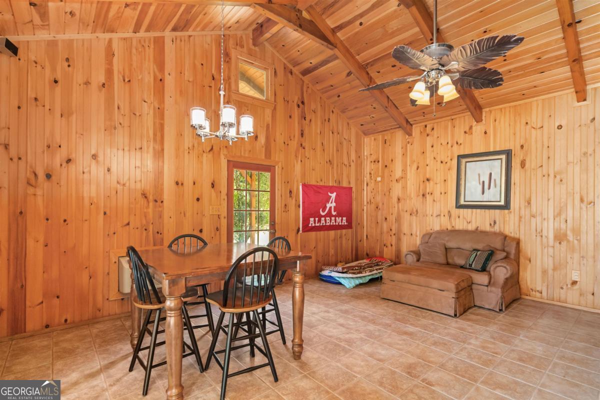 224 Harmony Road Eatonton, GA 31024 - Photo 48 of 68 a living room with furniture and a chandelier