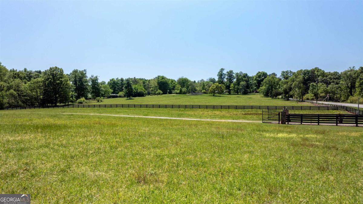 224 Harmony Road Eatonton, GA 31024 - Photo 59 of 68 a view of a swimming pool with an outdoor space and seating area