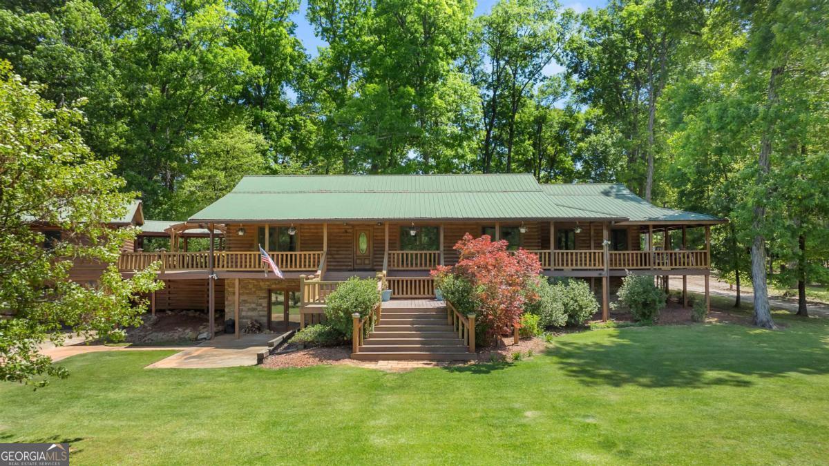 224 Harmony Road Eatonton, GA 31024 - Photo 6 of 68 a front view of a house with a garden