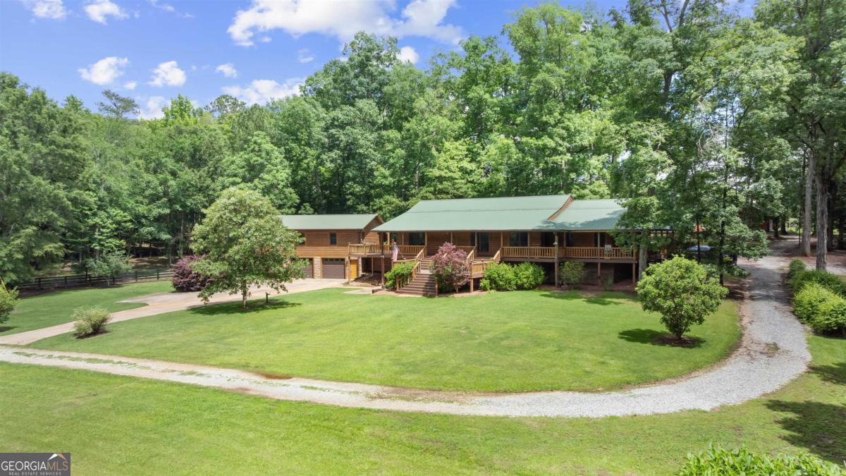 224 Harmony Road Eatonton, GA 31024 - Photo 64 of 68 a view of a house with a big yard potted plants and large tree