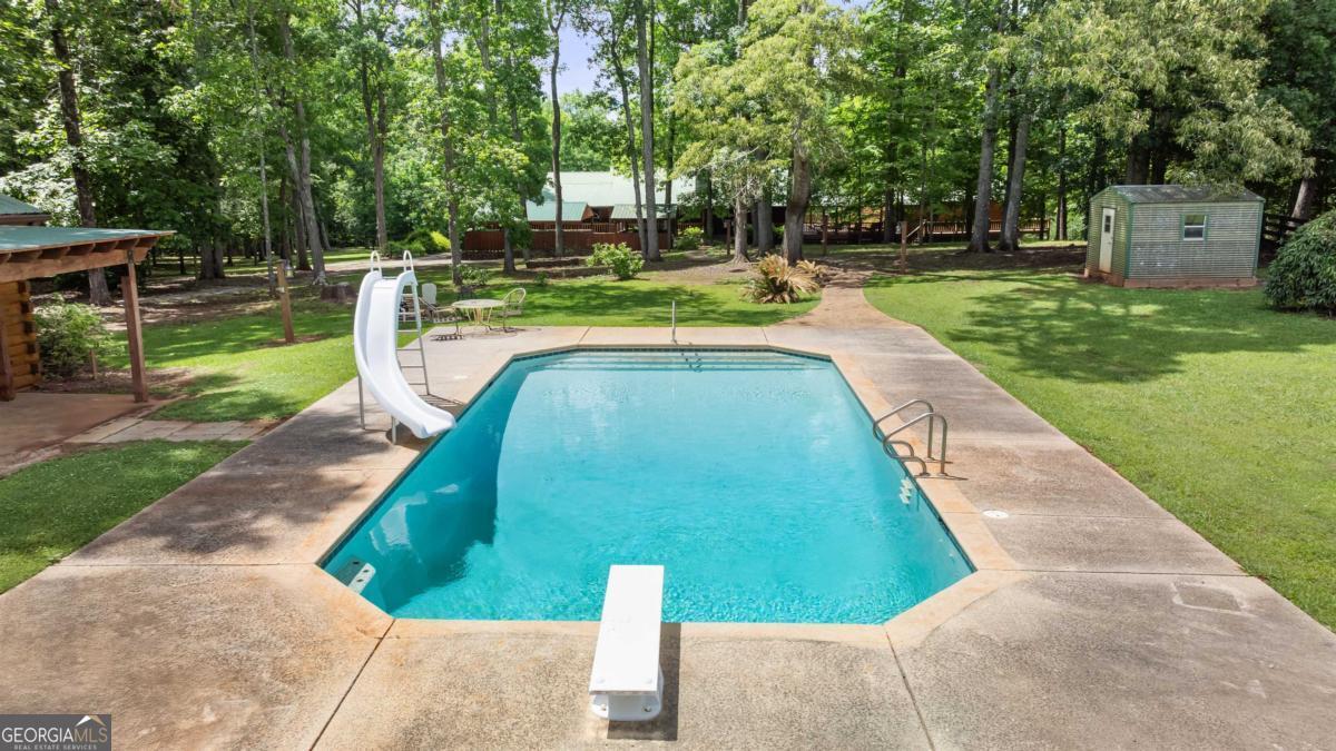 224 Harmony Road Eatonton, GA 31024 - Photo 9 of 68 a view of a backyard with swimming pool