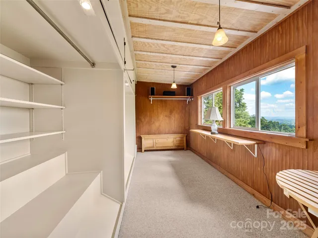 a view of hallway with stairs and furniture
