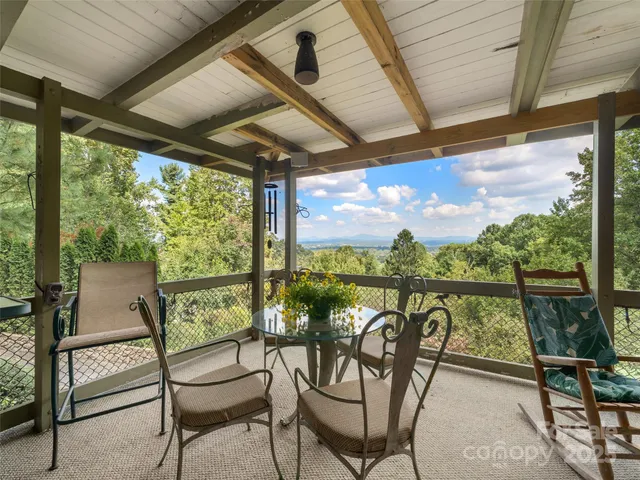 a view of a chairs and table in balcony