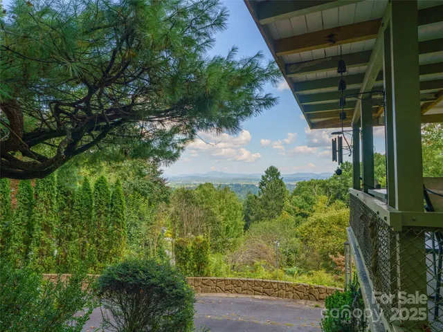 a view of a patio with table and chairs with wooden floor and fence