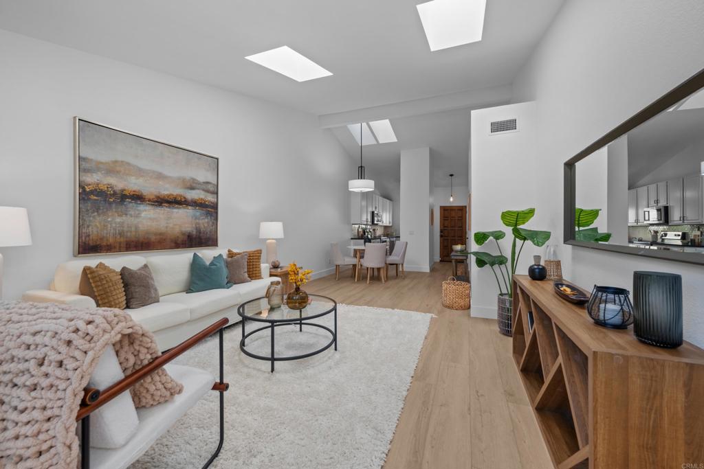 17823 Avenida Alozdra San Diego, CA 92128 - Photo 13 of 28 a living room with furniture a flat screen tv and a potted plant