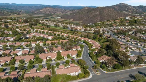 an aerial view of residential houses with outdoor space and street view