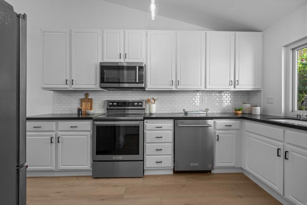 17823 Avenida Alozdra San Diego, CA 92128 - Photo 9 of 28 a kitchen with granite countertop white cabinets and stainless steel appliances