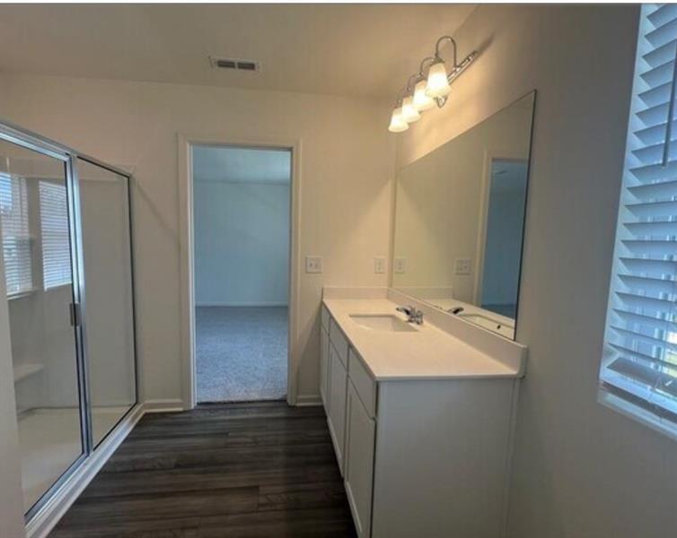114 Feeney Street Bethlehem, GA 30620 - Photo 6 of 14 a bathroom with a double vanity sink and mirror