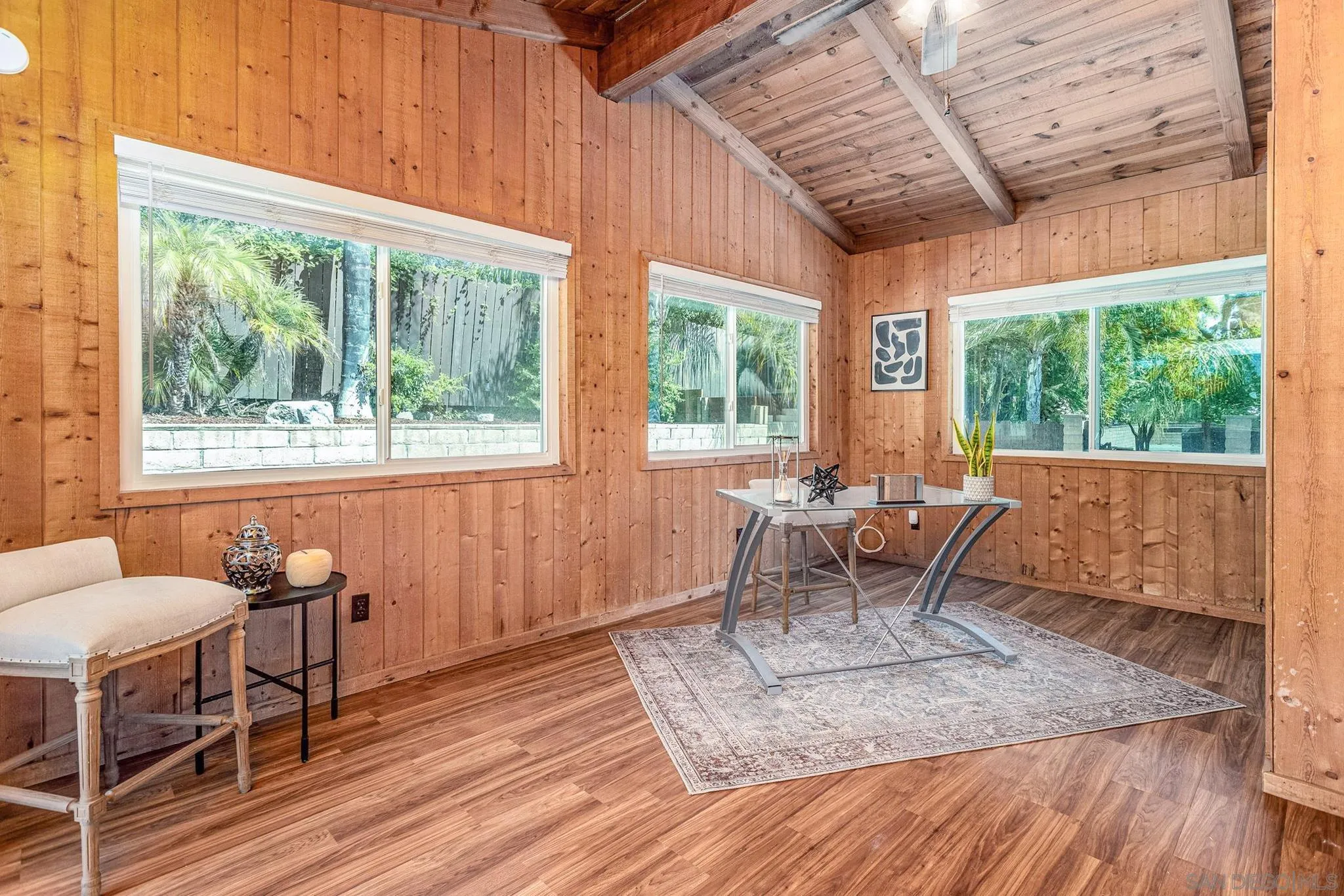 781 North Stage Coach Lane Fallbrook, CA 92028 - Photo 13 of 35 a dining room with wooden floor a chandelier a glass table and chairs