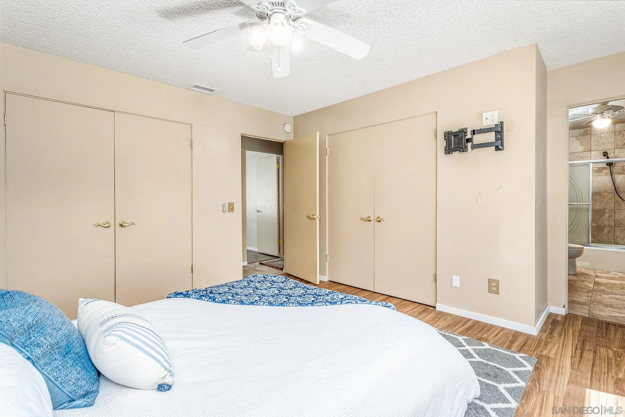 781 North Stage Coach Lane Fallbrook, CA 92028 - Photo 15 of 35 a bedroom with a bed and a chandelier