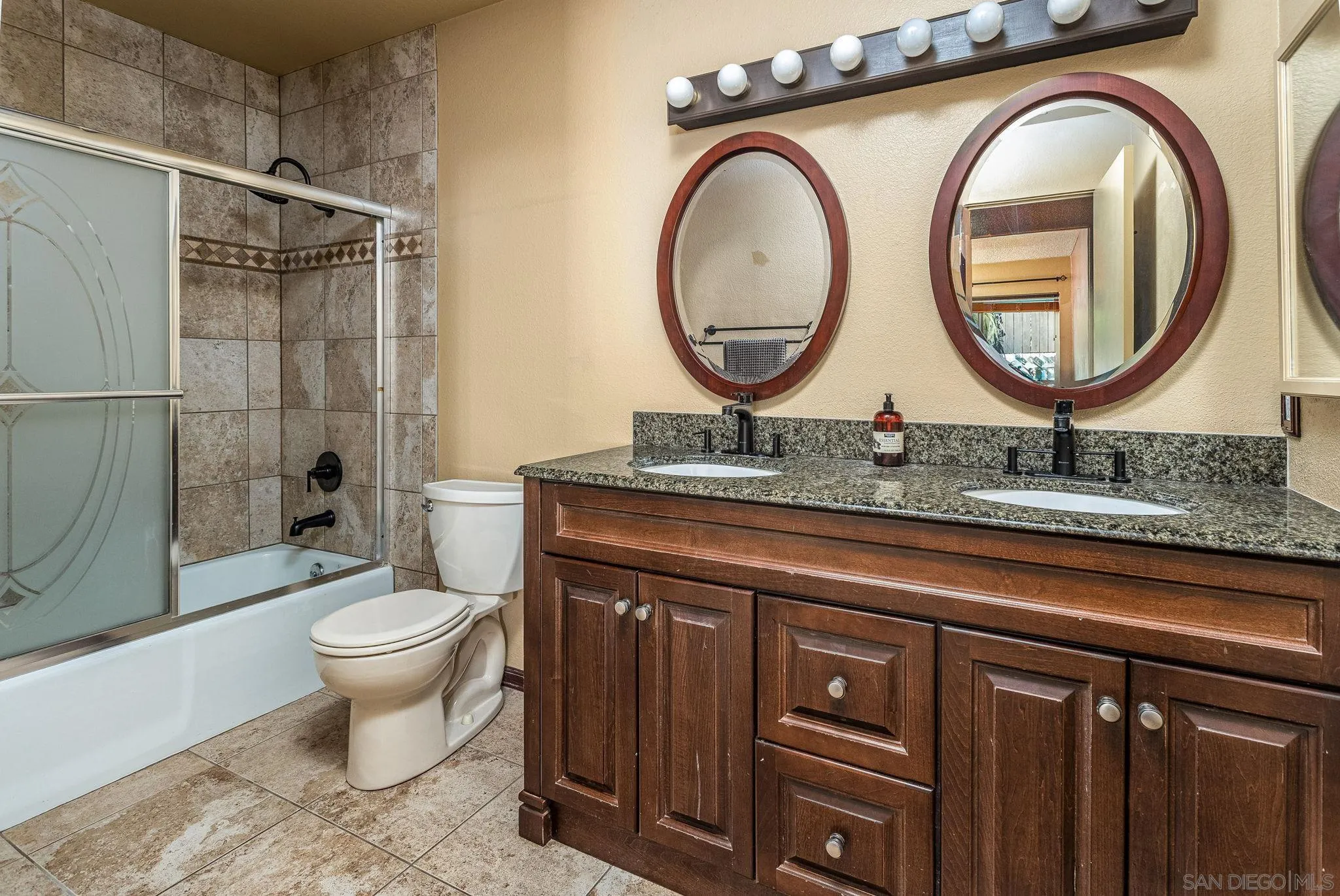 781 North Stage Coach Lane Fallbrook, CA 92028 - Photo 16 of 35 a bathroom with a toilet a sink and a mirror