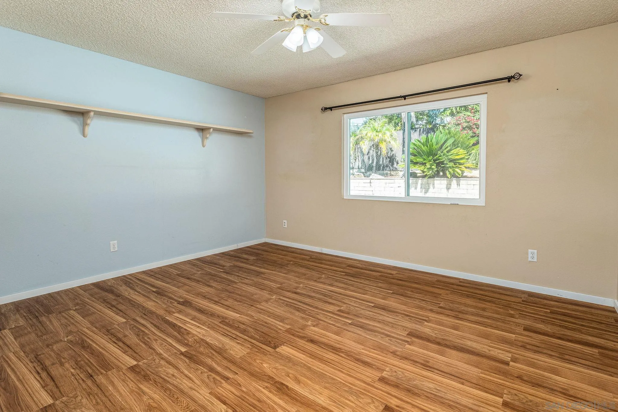 781 North Stage Coach Lane Fallbrook, CA 92028 - Photo 17 of 35 a view of an empty room with wooden floor and a window