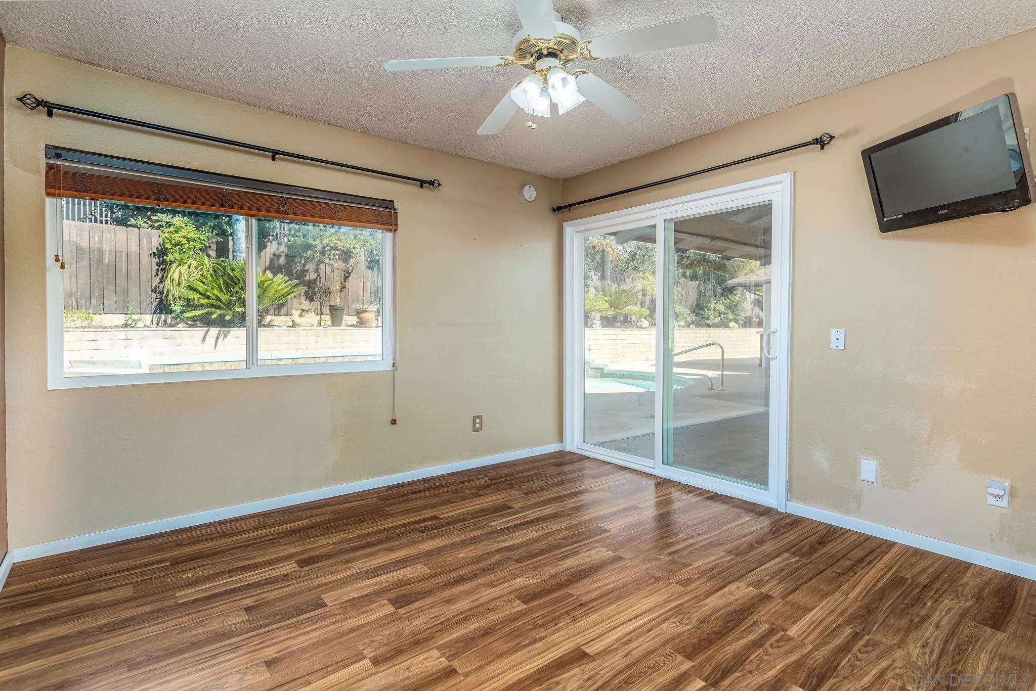 781 North Stage Coach Lane Fallbrook, CA 92028 - Photo 18 of 35 a view of empty room with wooden floor and fan