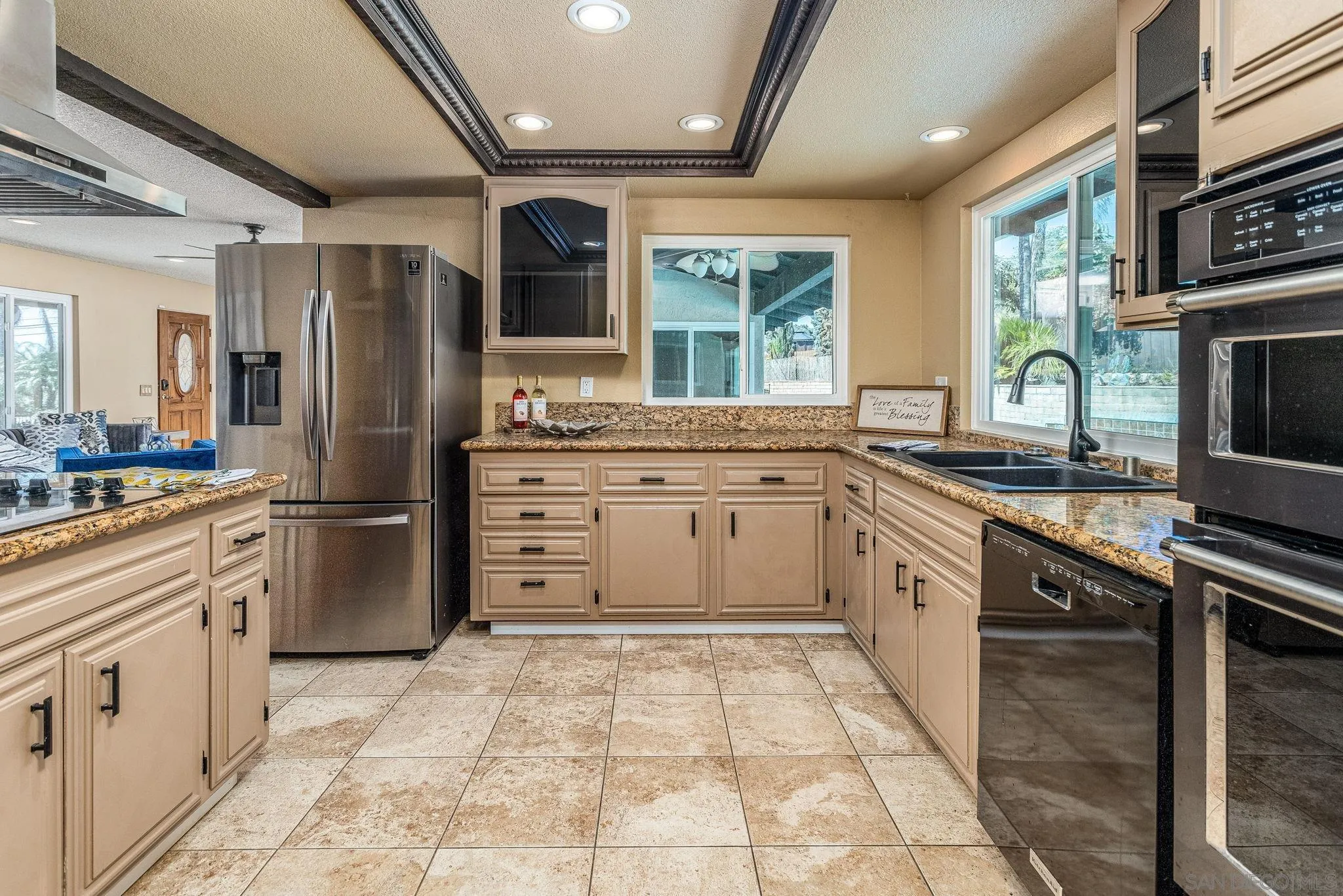781 North Stage Coach Lane Fallbrook, CA 92028 - Photo 4 of 35 a kitchen with stainless steel appliances granite countertop a stove refrigerator sink and microwave