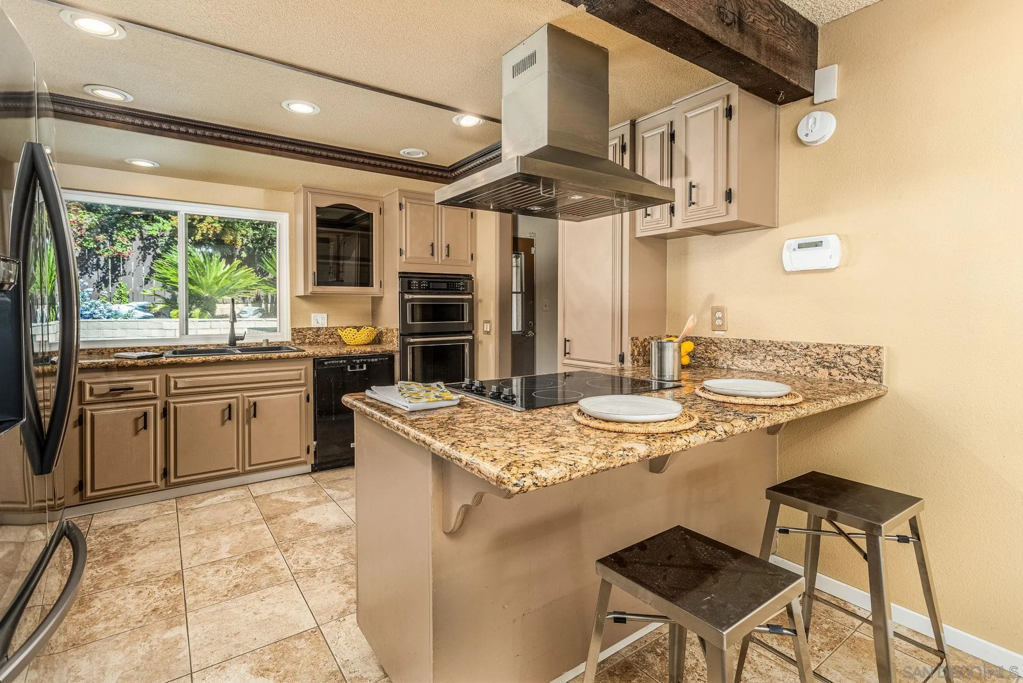 781 North Stage Coach Lane Fallbrook, CA 92028 - Photo 5 of 35 a kitchen with stainless steel appliances granite countertop a sink a stove and a refrigerator