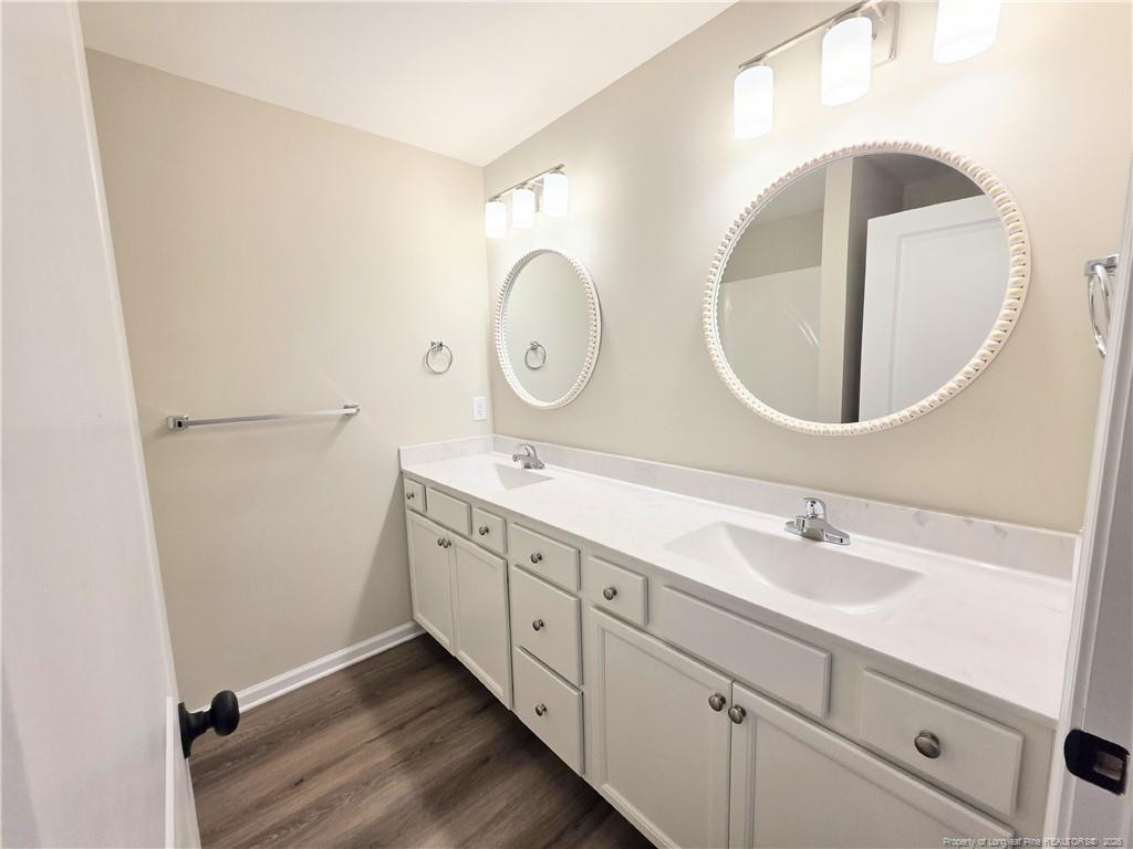 1511 Fort Bragg Road, Unit E Fayetteville, NC 28305 - Photo 11 of 15 a bathroom with a double vanity sink and a mirror
