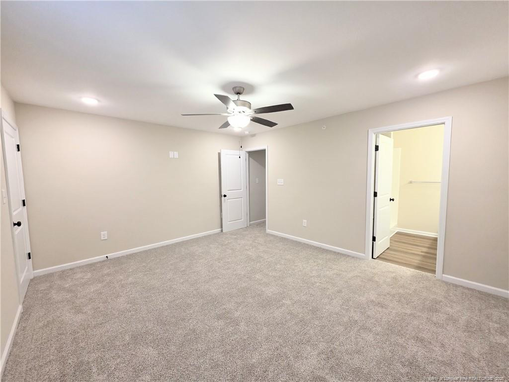 1511 Fort Bragg Road, Unit E Fayetteville, NC 28305 - Photo 6 of 15 an empty room with a ceiling fan and a window