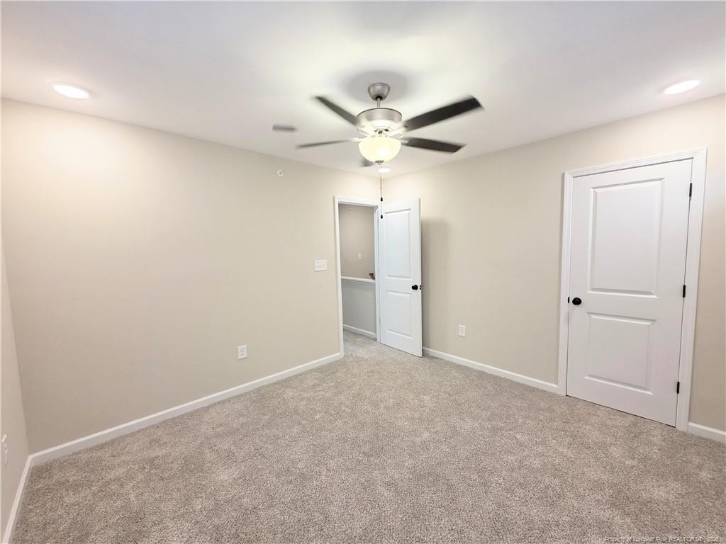 1511 Fort Bragg Road, Unit E Fayetteville, NC 28305 - Photo 9 of 15 an empty room with fan and a ceiling fan