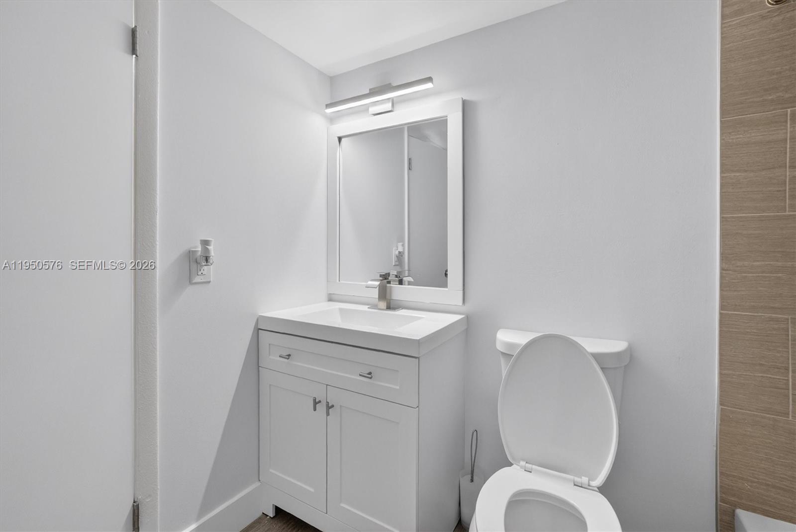 2075 Southwest 122nd Avenue, Unit 531 Miami, FL 33175 - Photo 13 of 27 a bathroom with a toilet a sink and mirror
