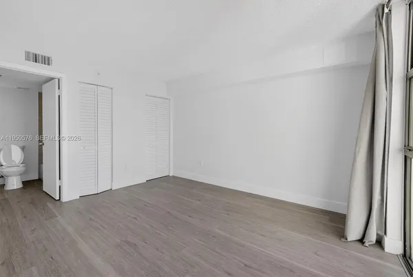 a view of a room with wooden floor and sink