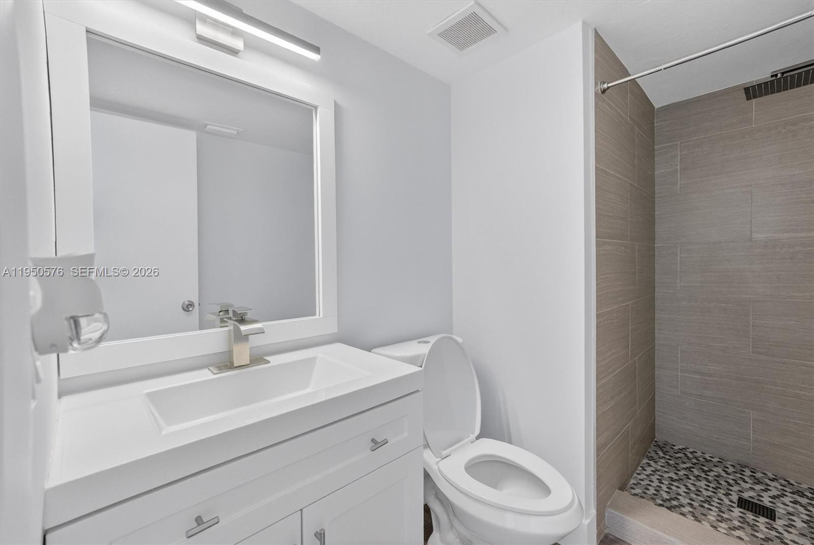 2075 Southwest 122nd Avenue, Unit 531 Miami, FL 33175 - Photo 18 of 27 a bathroom with a sink a toilet and shower