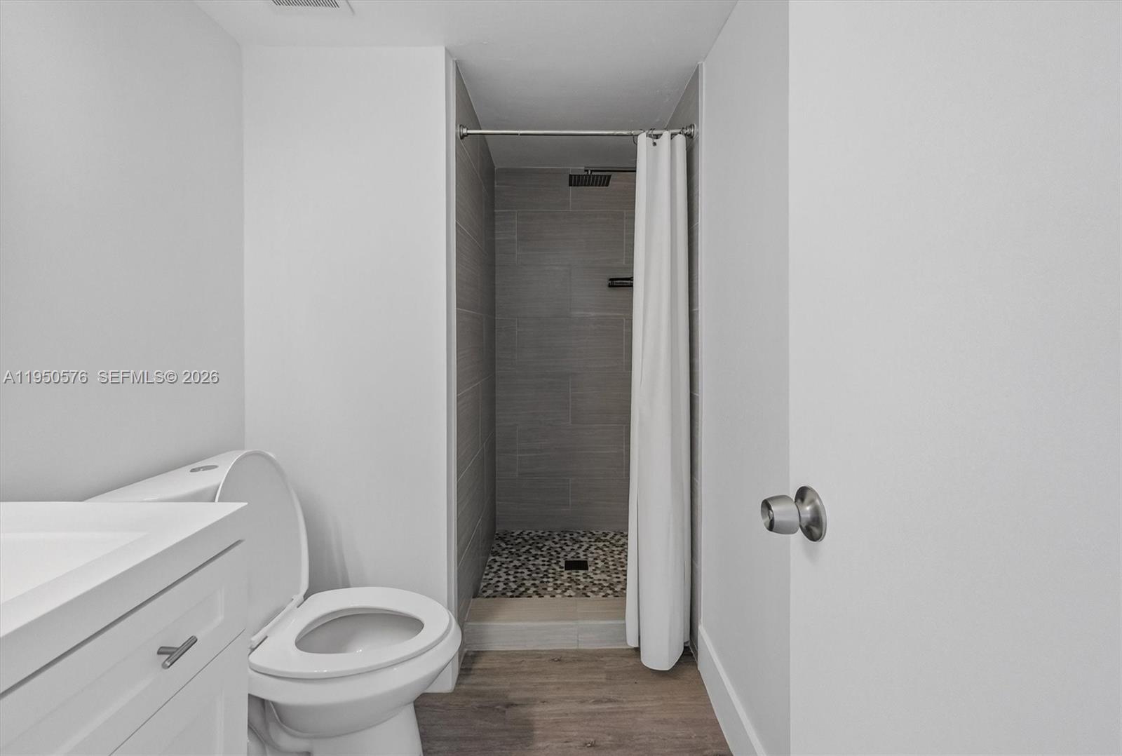2075 Southwest 122nd Avenue, Unit 531 Miami, FL 33175 - Photo 19 of 27 a bathroom with a granite countertop toilet a sink and shower