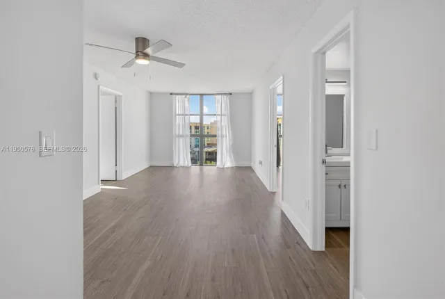 wooden floor in an empty room with a window